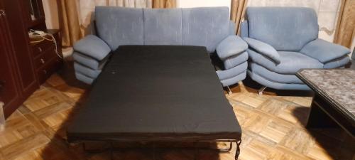 a coffee table in a living room with a couch and a chair at chalupa žamberk in Žamberk