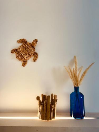 a blue vase with a stuffed turtle on a shelf at Villa Buon Vento in Vignacastrisi
