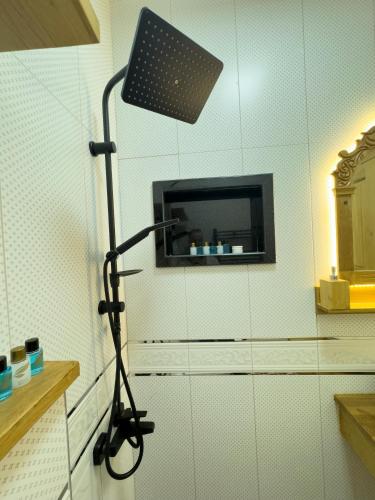 a black lamp in a room with a tv at İstanbul Eagle's Nest Boutique Hotel in Istanbul