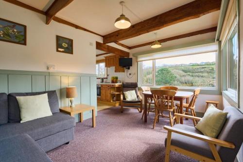 a living room with a couch and a table at Churchwood Valley in Plymouth