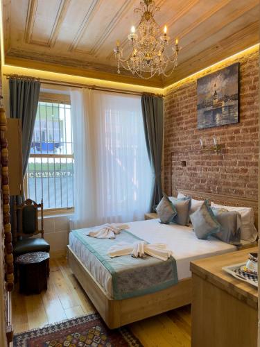 a bedroom with a bed and a brick wall at İstanbul Eagle's Nest Boutique Hotel in Istanbul