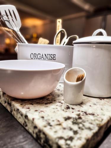 a counter top with a bowl and other kitchen utensils at Winterton Country Lodge @ Rose Cottage in Winterton