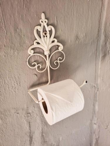 a toilet paper holder hanging from a wall at Winterton Country Lodge @ Rose Cottage in Winterton