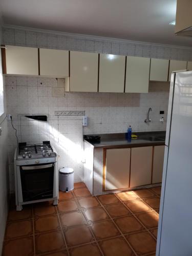 a kitchen with a stove and a sink in it at Pousada Monte Gerizim in Sao Paulo
