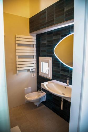 a bathroom with a sink and a toilet and a mirror at Divine House amalfi coast in Albori