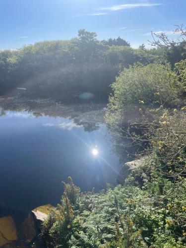 a body of water with the sun reflecting in it at Tresahor Studio in Falmouth