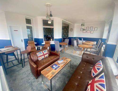 a living room with a couch and chairs and tables at The Fossil Tree Hotel in Blackpool