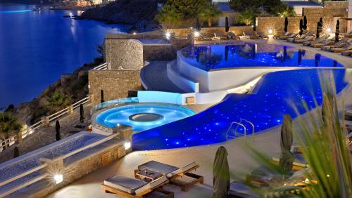 a pool in the middle of a resort at night at Anax Resort and Spa in Agios Ioannis Mykonos