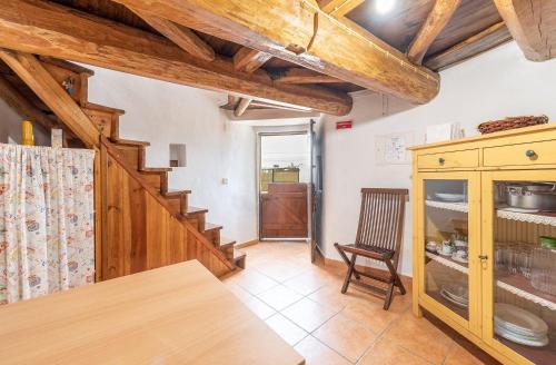 a kitchen with wooden ceilings and a wooden staircase at GuestReady - Lampas Wind Mill in Colares