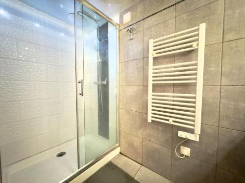 une douche avec une porte vitrée dans une salle de bain dans l'établissement Tres bel Appartement 5P Montmartre, à Paris