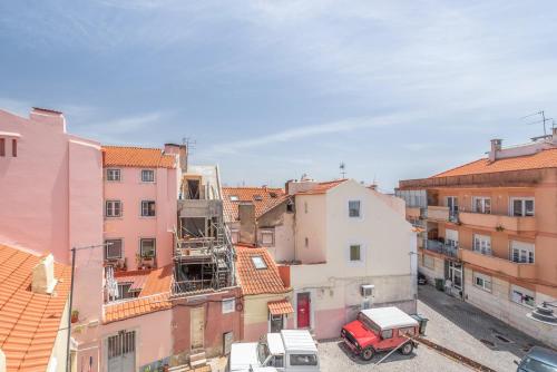 a view of a city with buildings and a red truck at GuestReady - Urban Garden Apartments in Lisbon