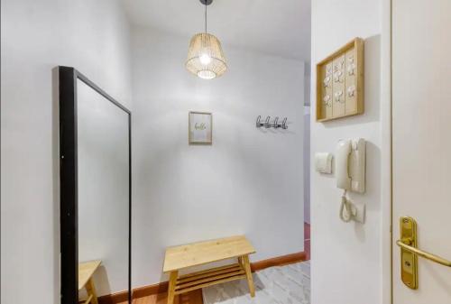 a hallway with a mirror and a table in a room at Paris Métro 7 Parking gratuit in Villejuif