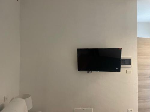 a flat screen tv hanging on a white wall at Residence Emma Lago di Viverone in Viverone