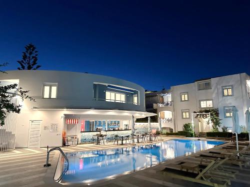 a large swimming pool in front of a building at Evdokia Suites in Gouves