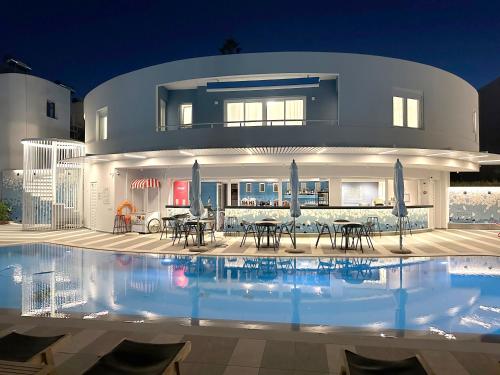 a house with a swimming pool in front of it at Evdokia Suites in Gouves
