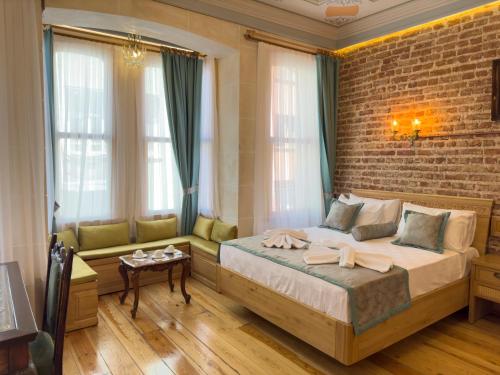 a bedroom with a bed and a brick wall at İstanbul Eagle's Nest Boutique Hotel in Istanbul