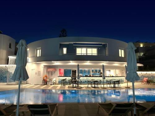 a house with a swimming pool at night at Evdokia Suites in Gouves
