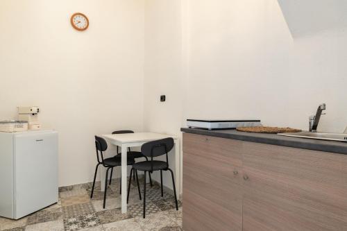 a kitchen with a small table and two chairs at Sg Apartment Standard Plus in Massafra