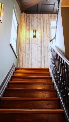 a set of stairs in a building with a curtain at Winzerhof Ross & Rose in Trechtingshausen