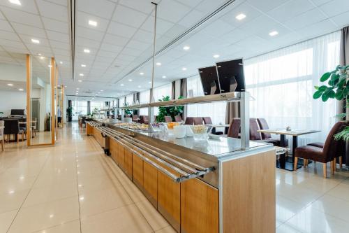 a restaurant with a counter with a buffet at GALANDA APARTMENTS in Turčianske Teplice