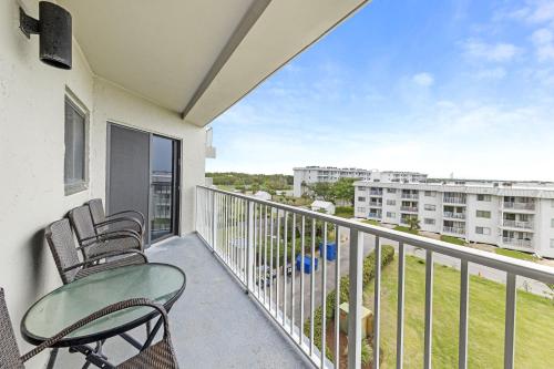 a balcony with chairs and a view of a building at Plantation Dunes Condos in Gulf Shores