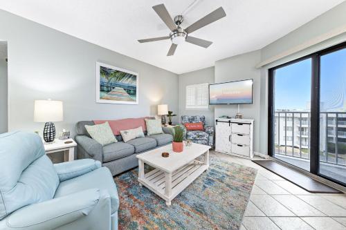 a living room with a couch and a tv at Plantation Dunes Condos in Gulf Shores