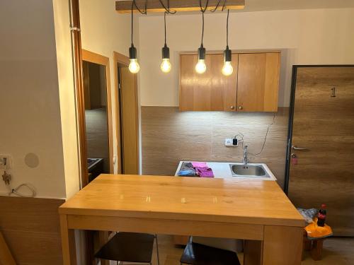 a kitchen with a wooden table and a sink at Aparthotel Jahorinski Konaci in Jahorina