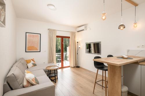 a living room with a couch and a table at Apartments Maria in Cavtat