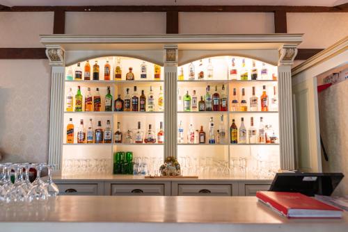 a bar with a lot of bottles of alcohol at Casa del Sole Boutique Hotel Timisoara in Timişoara