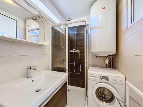 une salle de bain avec un lavabo et une machine à laver dans l'établissement Appartement Moderne et Lumineux à 2 Pas de la Plage, Parking Inclus - FR-1-770-27, à La Ciotat