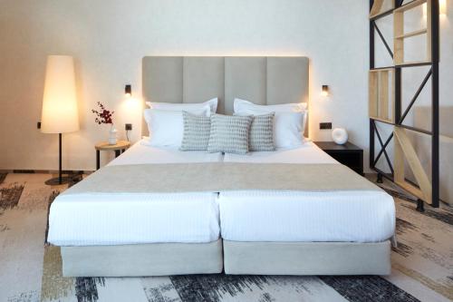 a bedroom with a large white bed with white pillows at Hotel Marvel All Inclusive - FULLY RENOVATED FREE Beach Access in Sunny Beach