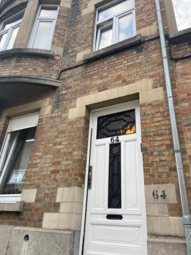 a brick building with a white door with the number at Chambre Neptune in Brussels