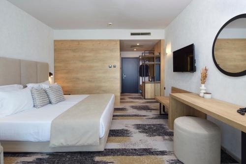 a hotel room with a bed and a mirror at Hotel Marvel All Inclusive - FULLY RENOVATED FREE Beach Access in Sunny Beach