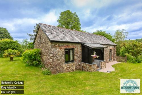a small stone house in a green yard at Puddleduck Valley in Holsworthy
