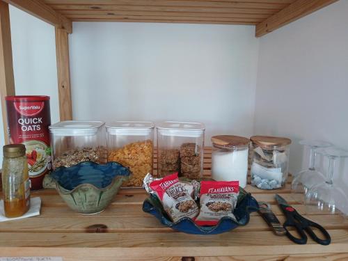 a wooden table with jars of food and other ingredients at Tinnock B&B in DʼLoughtane Cross Roads
