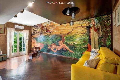 a living room with a large painting on the wall at Ai Colli 136, Terre Marine in La Spezia