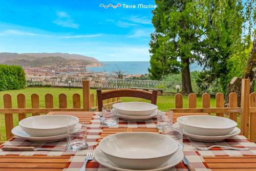 a table with plates and bowls on top of it at Ai Colli 136, Terre Marine in La Spezia