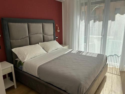 a bedroom with a large bed with a large window at Wow Rome Home in Rome