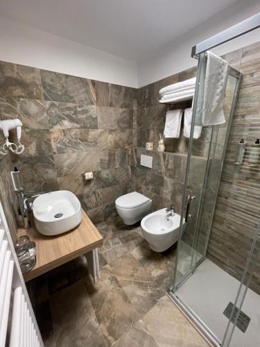 a bathroom with a shower and a toilet and a sink at SAINT MICHEL in Gorizia