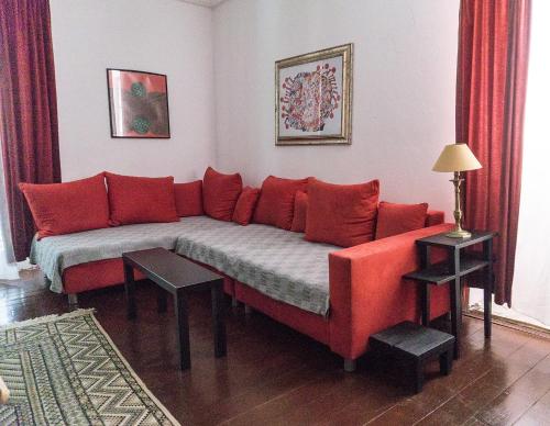 a couch in a living room with red pillows at Giunio house, Old town centre in Korčula