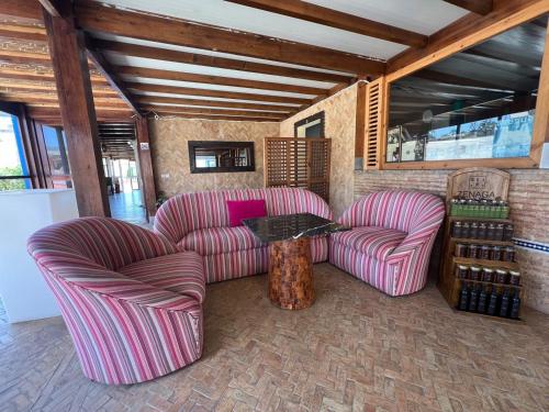two striped chairs and a table in a room at Ocean Dunes House in Mirleft