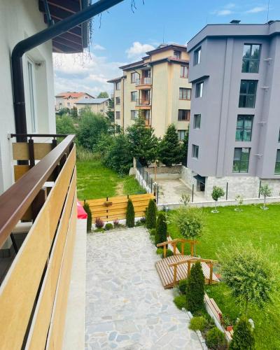 a balcony view of a park with benches and buildings at Villa Pino in Velingrad