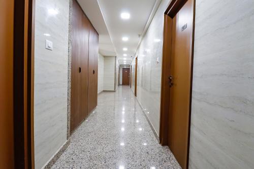 a corridor in a building with a long hallway at FabExpress Sathya Comforts - Nr Commercial Street in Bengaluru
