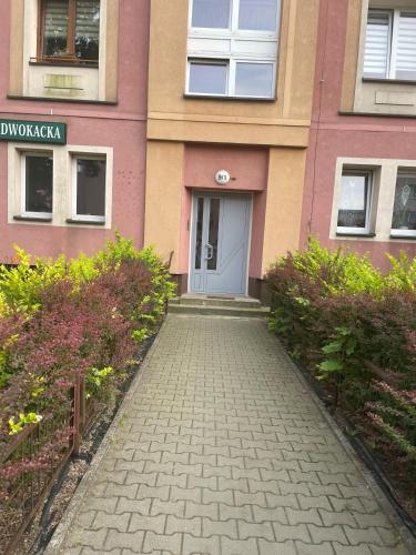 a walkway in front of a building with a door at Tiny Studio Pyskowice with parking in Pyskowice
