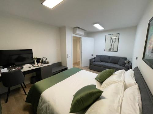 a bedroom with a bed and a desk and a couch at SAINT MICHEL in Gorizia