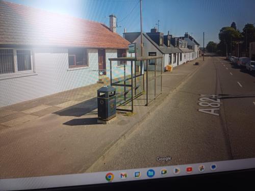 an empty street with a bus stop on the side of a building at Viewlands house in Auchterarder