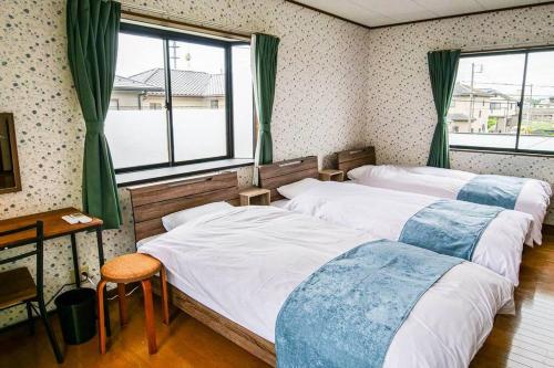 Postel nebo postele na pokoji v ubytování Villa228KASAMA