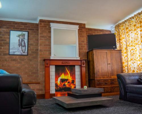 a living room with a fireplace and a tv at Rent Entire Calmhaven Apartment in Nottingham