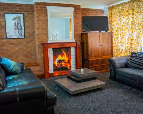 a living room with a couch and a fireplace at Rent Entire Calmhaven Apartment in Nottingham
