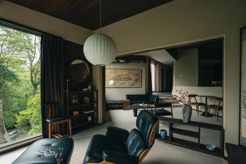 a living room with a couch and a table at AKNOT hakone 大涌谷を望むモダニズム建築 東京から90分 in Hakone